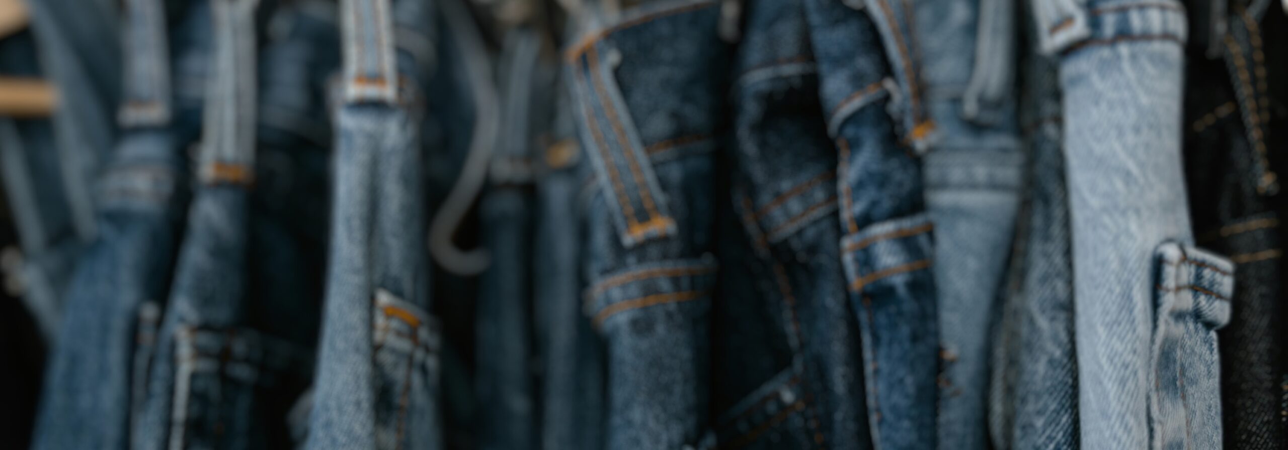 jeans hanging from a rack